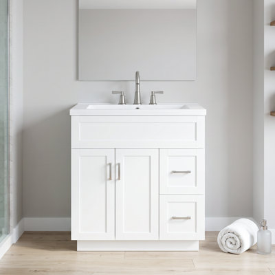 Meuble-lavabo standard autoportant en MDF de 76 cm (30 po), blanc, avec lavabo en résine, tiroirs à fermeture amortie et étagères à deux niveaux. Robinetterie non incluse.