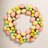 13" Artificial Pastel Easter Egg Wreath on a grapevine base.