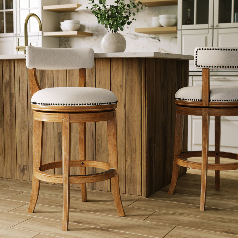 Tabouret de comptoir pivotant rembourré avec structure en bois massif Carollynn