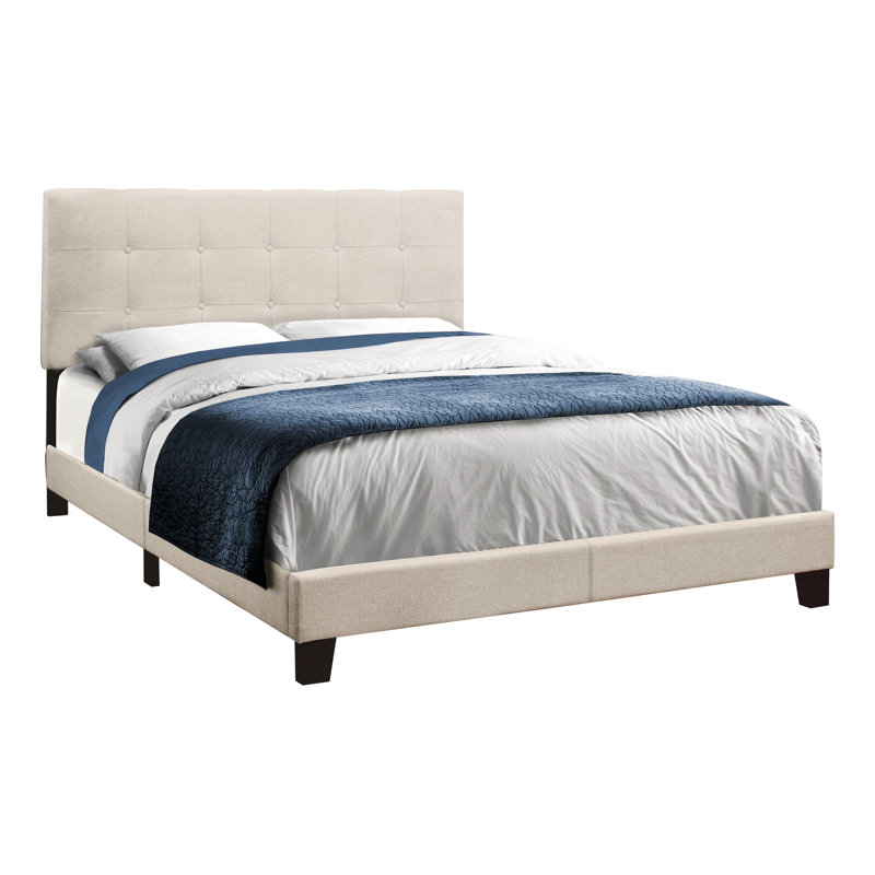 Lit tapissier beige en lin avec pieds noirs stables et tête de lit plateforme