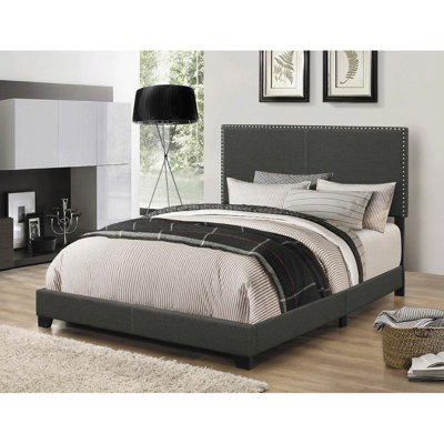 Gris anthracite, très grand lit à panneau oriental, forme rectangulaire, quatre pieds, garniture cloutée classique, revêtement de chambre à coucher, conception de soutien,