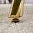 63-inch Black Marble-Patterned Tempered Glass Dining Table with Single-Fork Golden Metal Legs for Modern, Durable, and Stylish Dining Spaces.