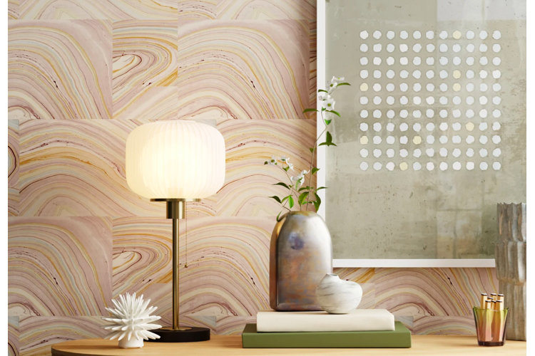 marble print wallpaper behind a modern console table, brass table lamp, and green abstract wall art