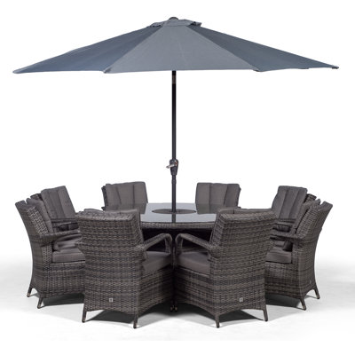 Karas 8 - Person Wicker Patio Dining Set with Round Table , Cushions Included