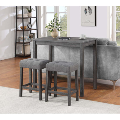 Ensemble de table bistro trois pièces à hauteur de comptoir avec tabourets capitonnés, idéal pour rehausser votre expérience de repas et de socialisation