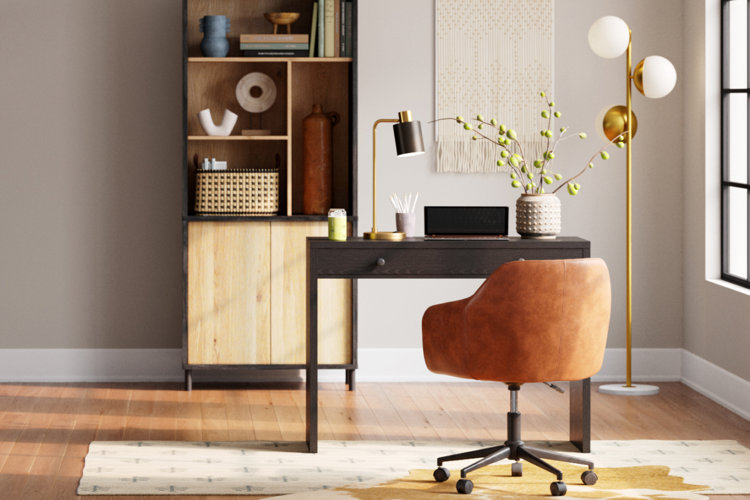 modern home office with an espresso wood desk, leather desk chair, black-and-gold task lamp, and a laptop