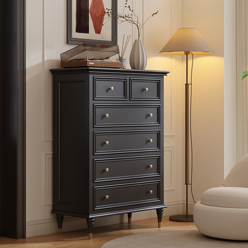 Armoire cinq tiroirs en bois massif noir avec pattes décoratives dorées
