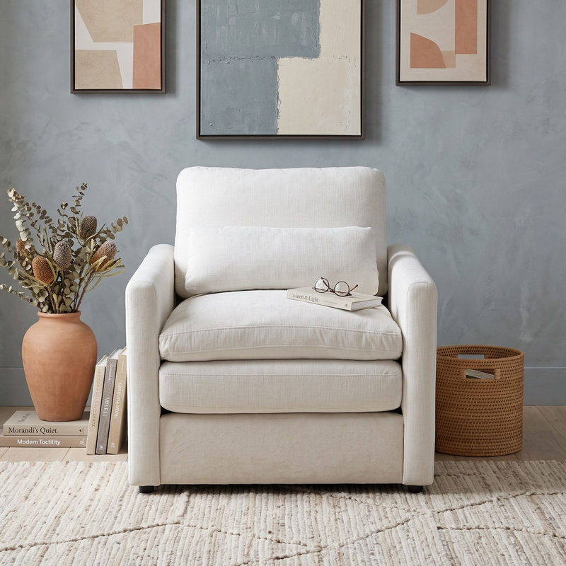 Fauteuil rembourré avec coussin double couche, accoudoirs roulés, coussin lombaire, assise profonde et dossier amovible
