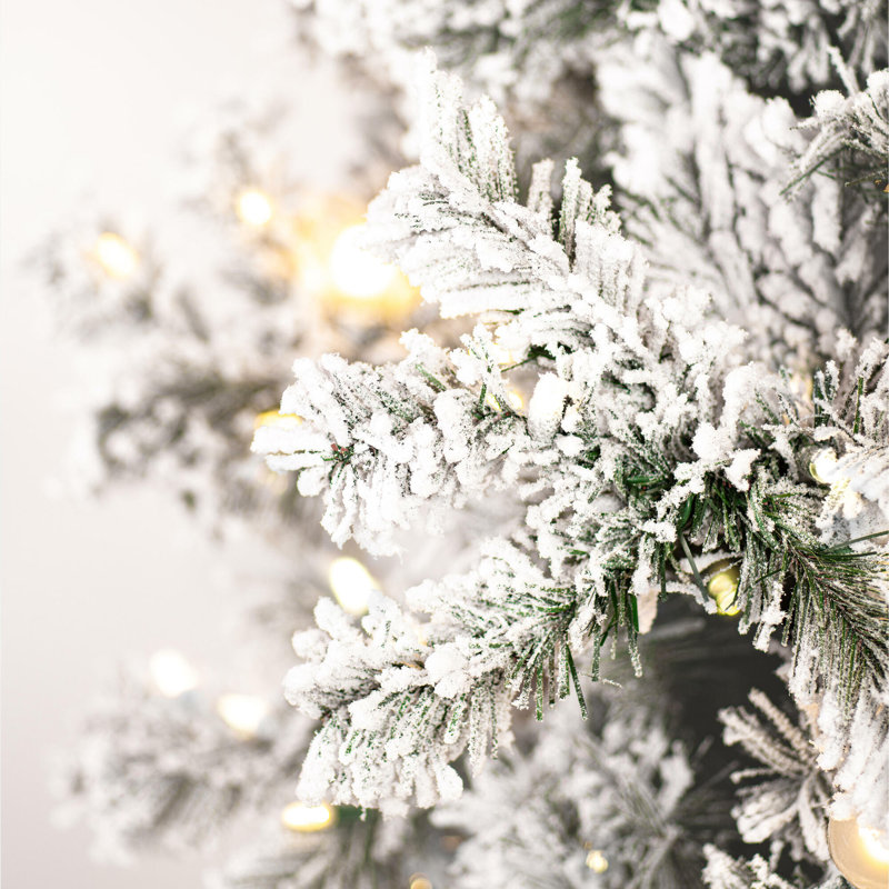 Vickerman 7.5' x 48" Flocked Slim Alaskan Artificial Unlit Christmas Tree with 1088 FlockedClassic PVC Tipsand Folding Metal Tree Stand. Assembly is required.