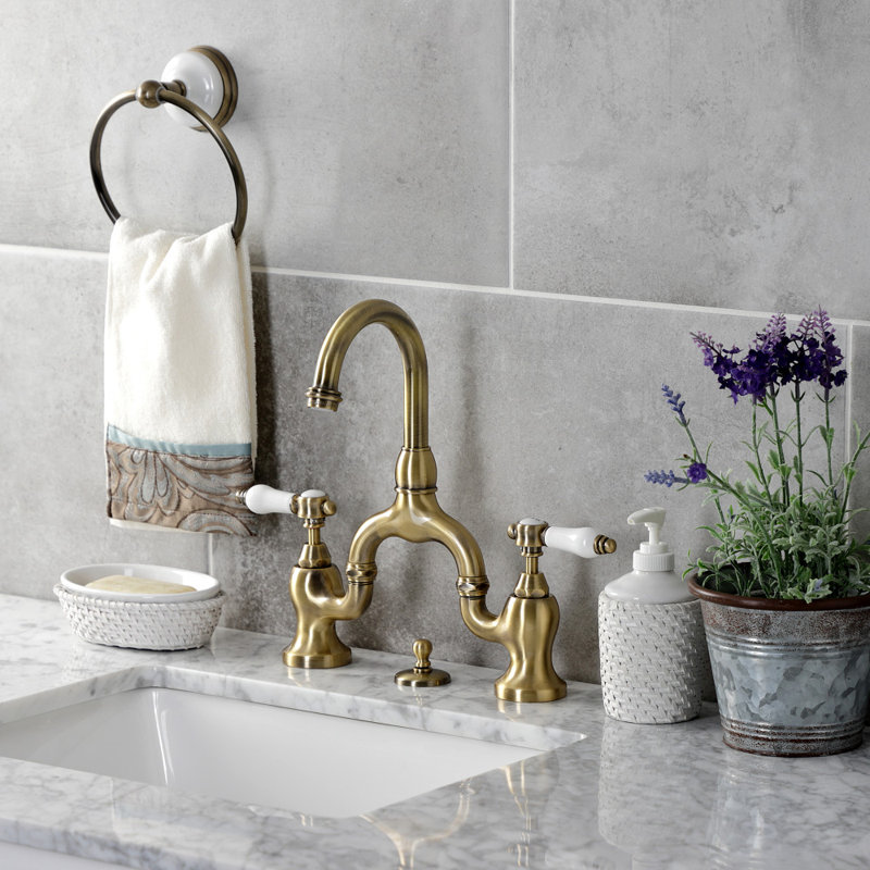 Kingston Brass Bel-Air Two-Handle 3-Hole Deck Mount Bridge Bathroom Faucet with Brass Pop-Up, Antique Brass