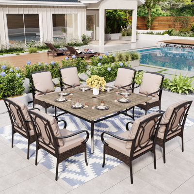 Sutiya 8 - Person Stainless Steel Patio Dining Set Umbrella Hole Included Square Table with Cushions Included