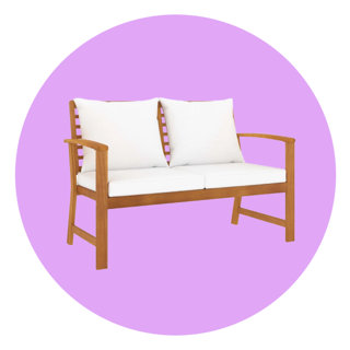 Wooden garden bench with white seat and back cushions against a lilac circular background.