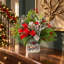Festive holiday arrangement with greens and Berries