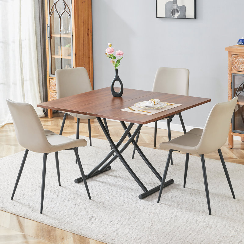 Ensemble de table de salle à manger multifonctionnel à finition en bois aggloméré et pieds en métal noir avec 4 chaises en cuir PU pour la vie moderne, la salle à manger et les espaces d'étude
