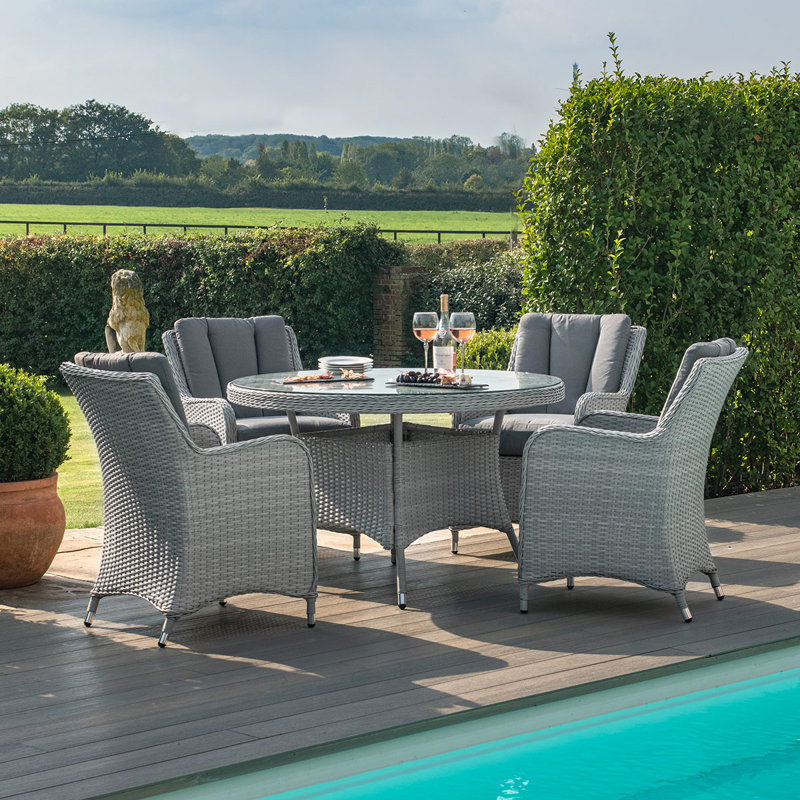 Crimora 4 - Person Wicker Patio Dining Set with Round Table , Cushions Included
