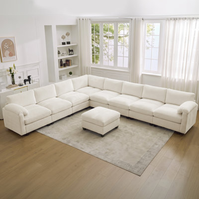 Canapé modulaire 8 places avec accoudoirs coussinés et repose-pieds