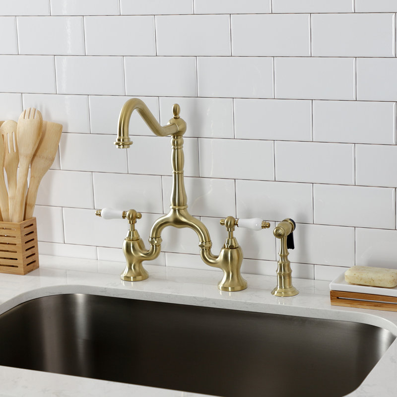 Kingston Brass English Country Two-Handle 3-Hole Deck Mount Bridge Kitchen Faucet with Brass Side Sprayer, Brushed Brass