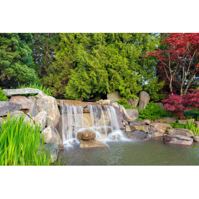 Garden Backyard Landscaping With Rocks Boulders Waterfall Trees And Plants by JPLDesigns - Wrapped Canvas Print