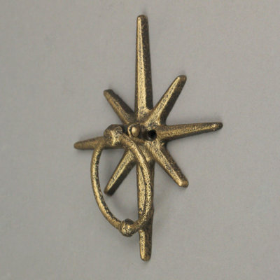 Rustic celestial cast iron starburst front door knocker in antique gold with mounting holes — 5" L x 1.25" W x 6.25" H