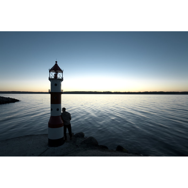 Man Leaning Against Lighthouse - Wrapped Canvas Print, 61cm H x 91cm W