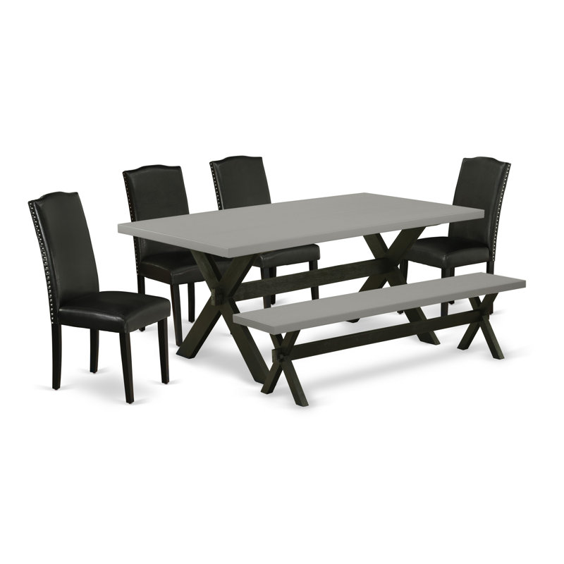 L'ensemble de table de salle à manger 6 pièces contient une table de salle à manger rectangulaire avec pieds en X et 4 chaises Parson en simili cuir noir avec banc, noir brossé