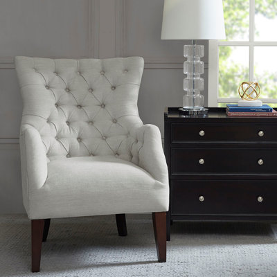 Fauteuil à oreilles capitonné