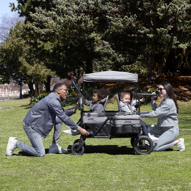 Jeep Wrangler Deluxe 4 Seater Stroller Wagon by Delta Children - Premium Stroller Wagon for 4 Kids with Convertible Seats, Adjustable Push/Pull Handles, Removable Canopy & Flat Fold