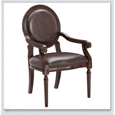 Fauteuil formel traditionnel avec similicuir brun foncé, garniture cloutée et structure en bois massif pour une élégance classique