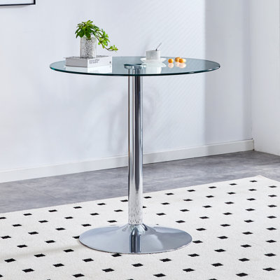 The modern and simple round glass dining table is equipped with silver-plated legs and is suitable for various scenarios