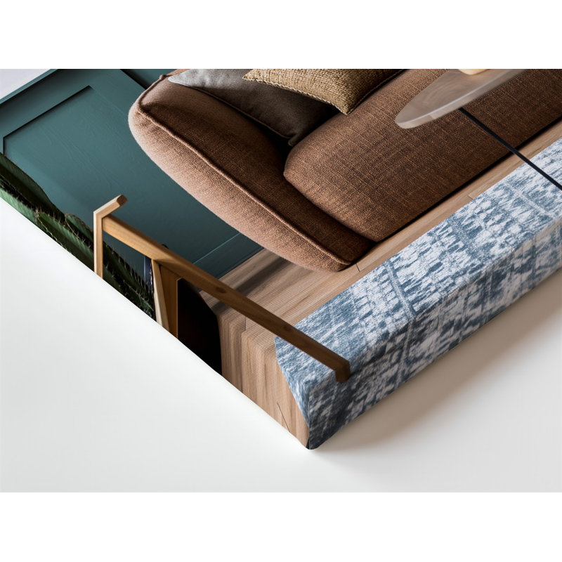Toile, un confortable salon avec un grand canapé brun texturé, orné de divers coussins positionnés contre un mur