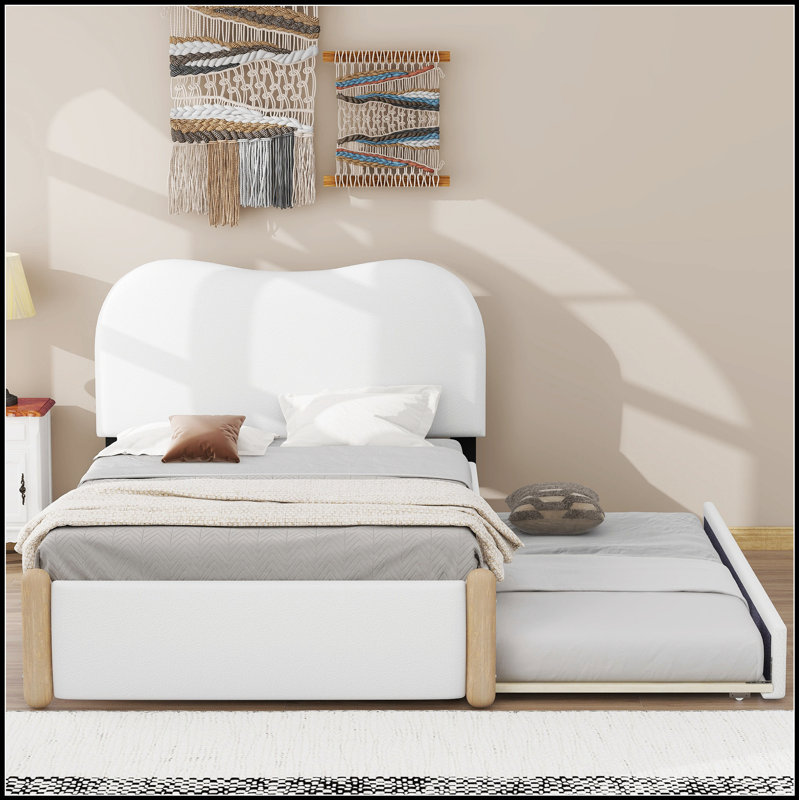 Lit plateforme tapissier avec pieds de soutien en bois et lit gigogne, durable et peu encombrant pour les chambres à coucher modernes.