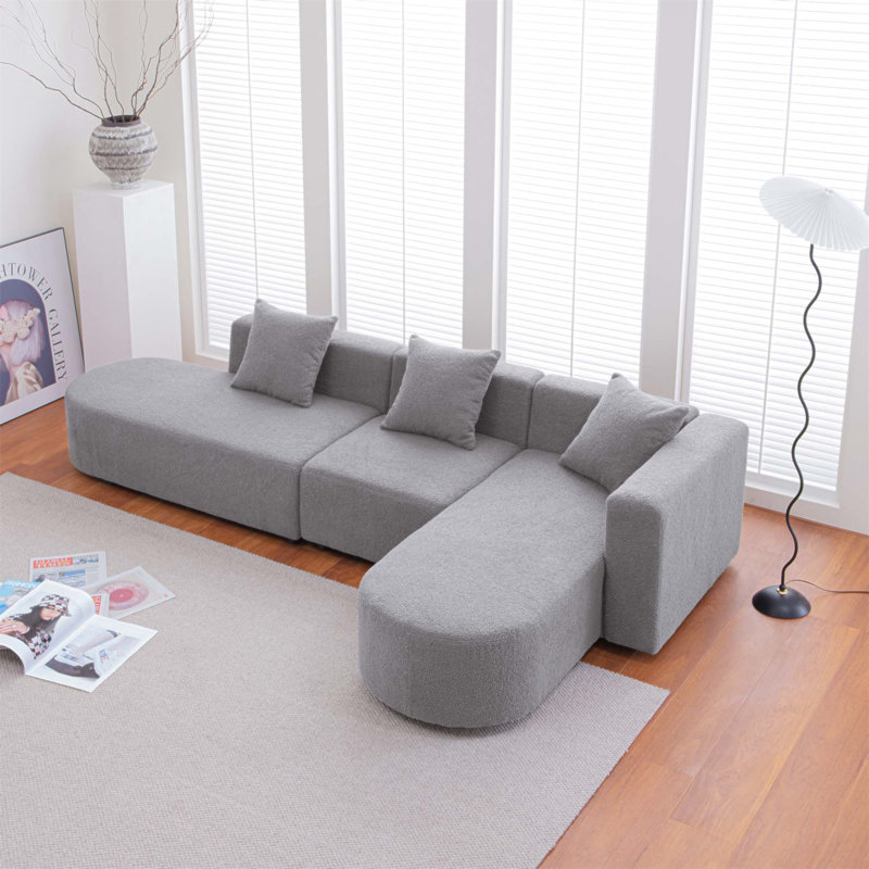 Modern L-Shape Boucle Sofa With Curved Seat, Perfect For Comfort And Stylish Living Rooms, Facing Right.