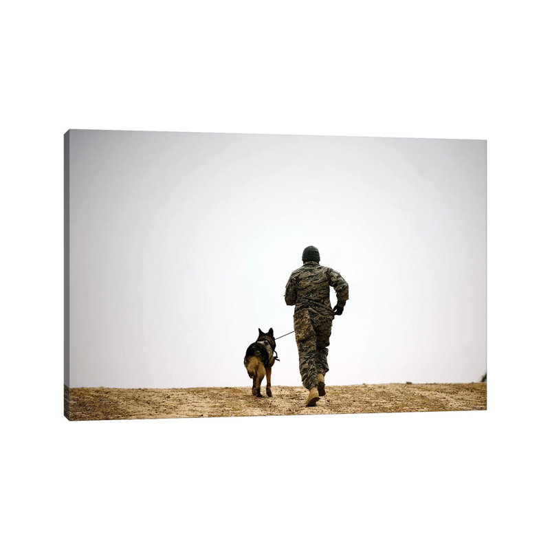 A Dog Handler And His Military Working Dog Take A Brisk Walk - Wrapped Canvas Print, 101.6 cm H x 66.04 cm W x 3.175 cm D