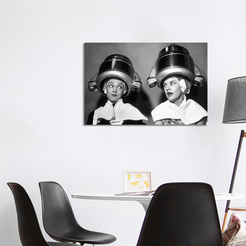 1950s Two Women Sitting Together Gossiping Under Hairdresser Hair Dryer by Vintage Images - Wrapped Canvas Print