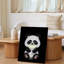 Toile, un joli panda de style dessin animé avec de la fourrure noire et blanche moelleuse est assis dans un environnement sombre tenant une tasse brillante pour l'art mural moderne sur toile-175495529