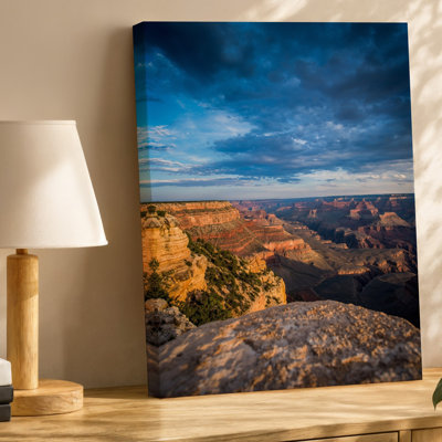 Canvas A Breathtaking Panoramic View Of A Vast Canyon Landscape Under Wall Art A Dramatic Sky Showcasing Layers Of Rugged Red And Canvas Wall Art