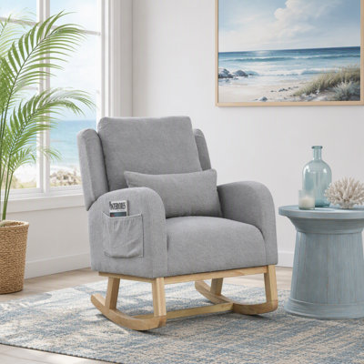 Fauteuil à bascule moderne et confortable avec dossier haut, coussin lombaire et poches latérales pour un confort optimal.