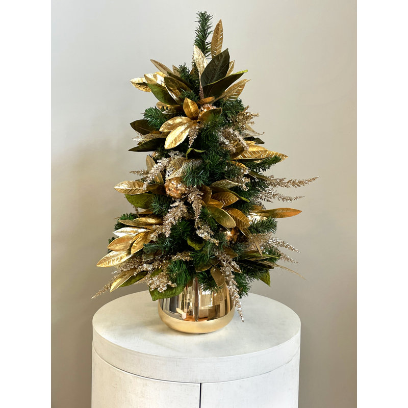 Holiday Tree with Magnolia Leaves and Ornaments in Glass Vase