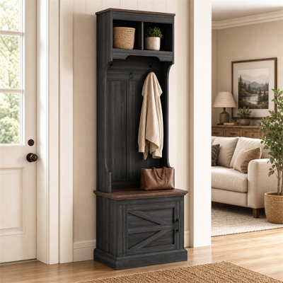 Meuble de rangement noir 3 en 1 à grain de bois noir - combinant une armoire à chaussures, un banc et des crochets à manteau - pour répondre aux besoins de rangement du vestibule.
