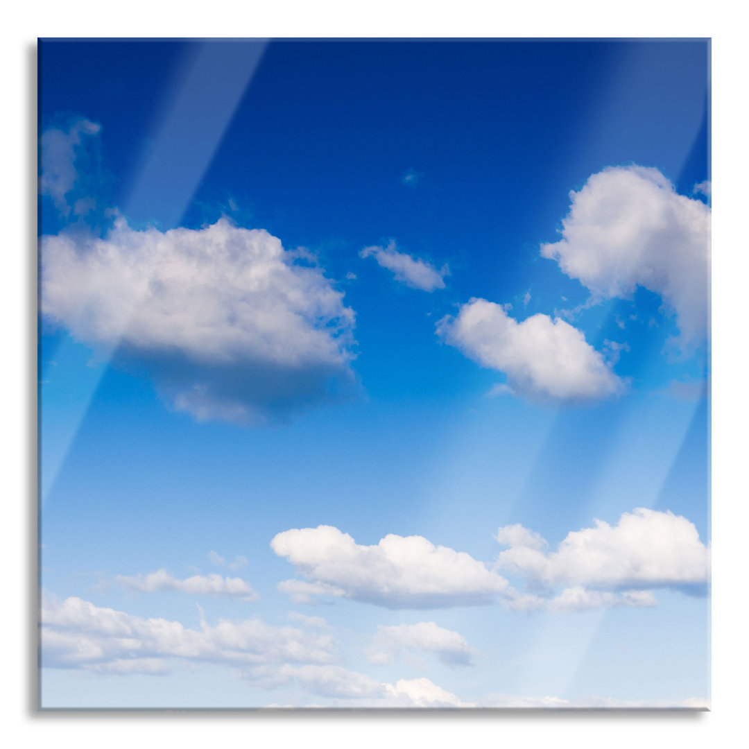 Glasbild Wolken am blauen Himmel