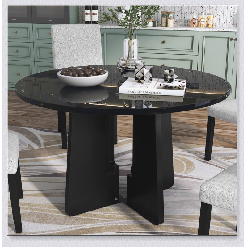 Table de salle à manger ronde en faux marbre pour quatre personnes avec un piètement robuste, idéale pour les maisons modernes et les espaces commerciaux.