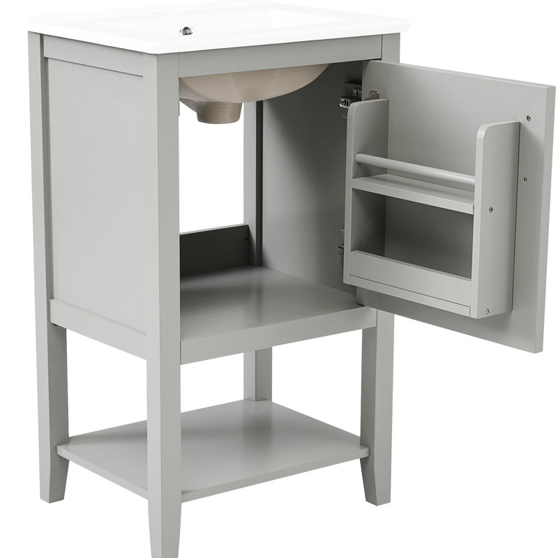 Meuble-lavabo gris avec lavabo de 50 cm, en bois massif, avec tablette de rangement et design pratique.