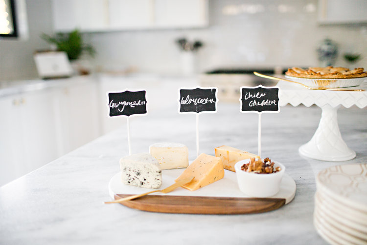 Cheese on a marble and wooden cutting board.