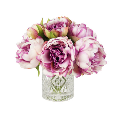Pivoines disposées dans un vase en verre