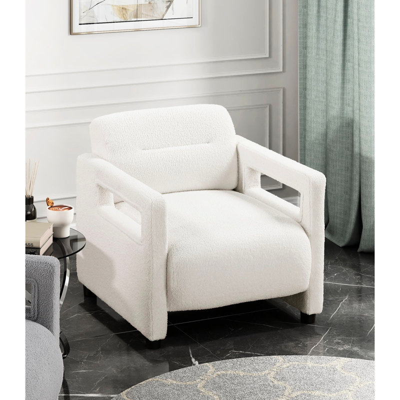Fauteuil beige avec une structure en contreplaqué stable et un revêtement en forme de boucle pour un rembourrage élégant à structure tactile