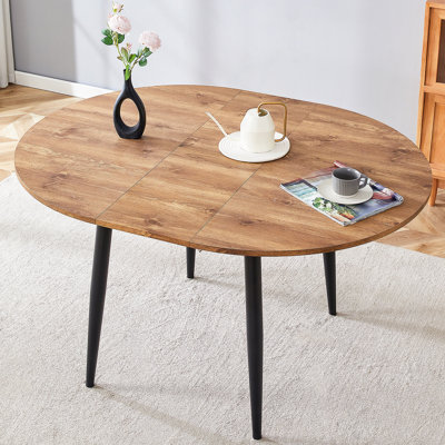 Avec un mécanisme rétractable astucieux, le plateau de table en bois aggloméré et les pieds en métal noir ont une surface lisse et délicate. Le look unique crée la silhouette élégante d'une maison moderne.