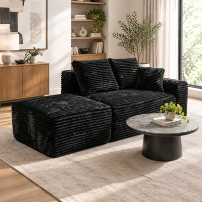 Petit canapé d'angle modulaire Cloud avec pouf, siège profond et 3 coussins, velours côtelé noir, méridienne à droite