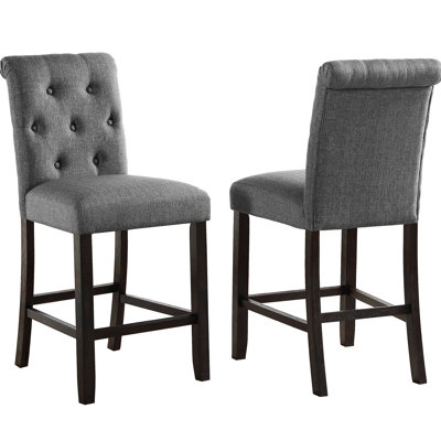Grey Counter Height Stool  2 . Solid Wood Build With Stylish Details. Cushioned Seats And Backs For Optimal Comfort. Dark Wooden Legs. Elegantly Curved High-Back Chairs. 23" W X 19" D 40.55" H. Seat