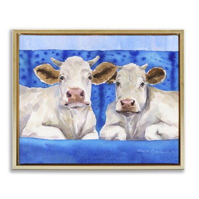 Cadre blanc flottant de vaches blanches sur un canapé bleu, design par George Dyachenko