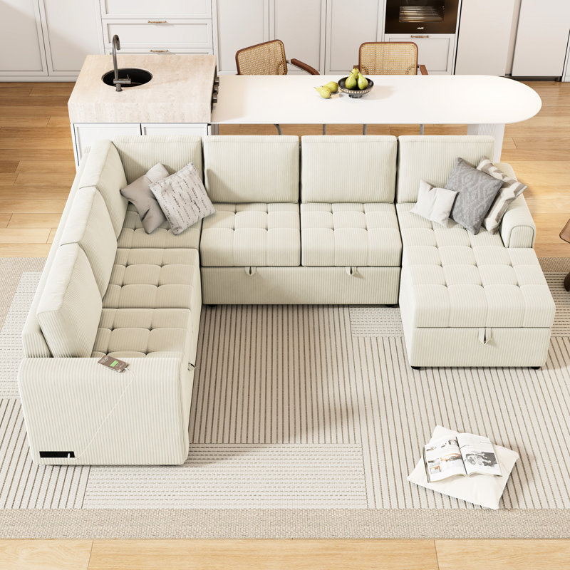 Lit escamotable beige avec méridienne modulaire en U et rangement pratique